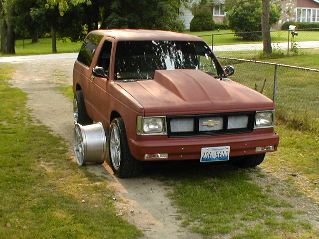 Red SUV with hood scoop and spare wheel