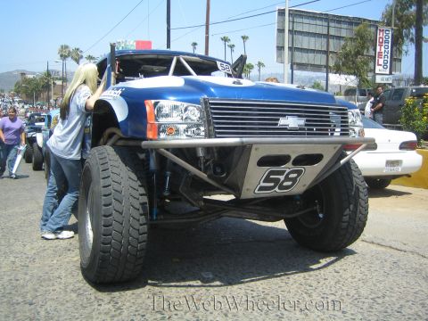 1990 Ford Bronco - Front view of a blue Chevrolet off-road prerunner truck numbered 58 with a bowtie grille, tube front bumper and exposed long-travel suspens…