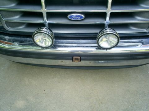 1994 Ford Bronco - Front view of a 1994 Ford Bronco showing the grille, emblem, auxiliary lights, and bumper.