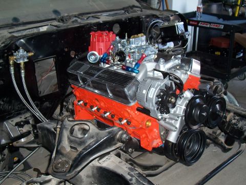1979 Chevrolet Camaro - Close-up of a V8 engine assembly, a bright orange block and various polished components.