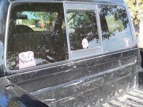 2003 Ford Ranger - Rear view of a pickup truck bed and window with stickers. Year is not discernible.