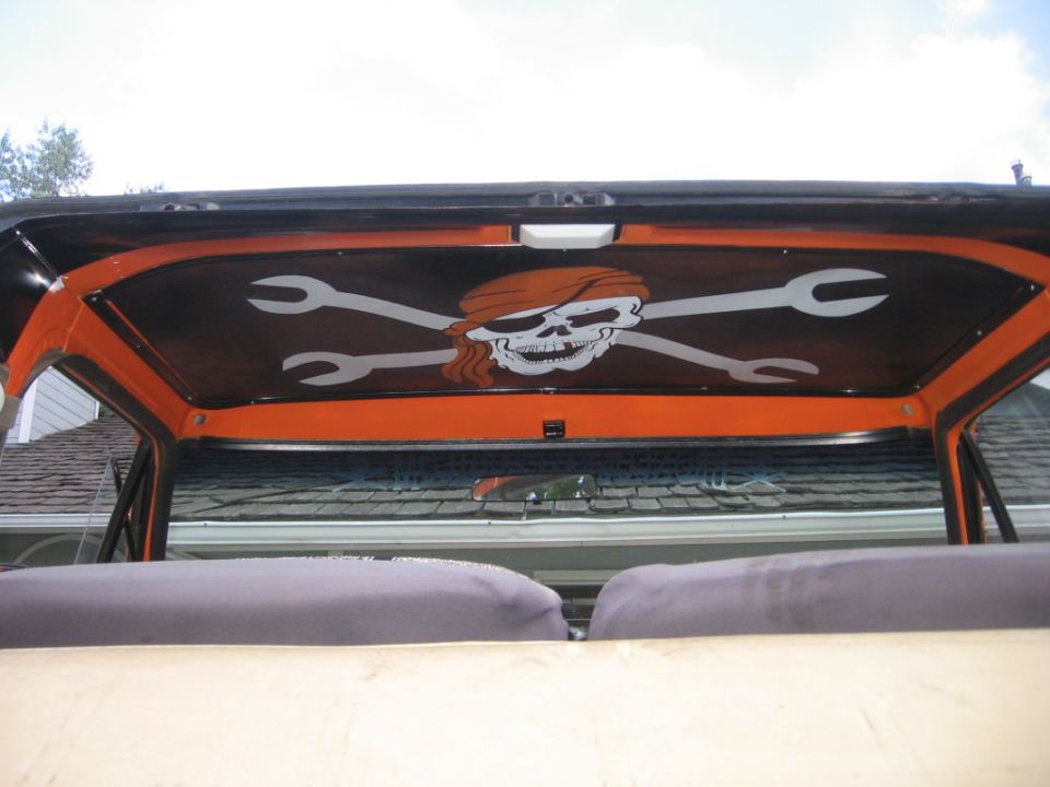 Interior shot of a vehicle's headliner with a custom skull and cross-wrenches graphic