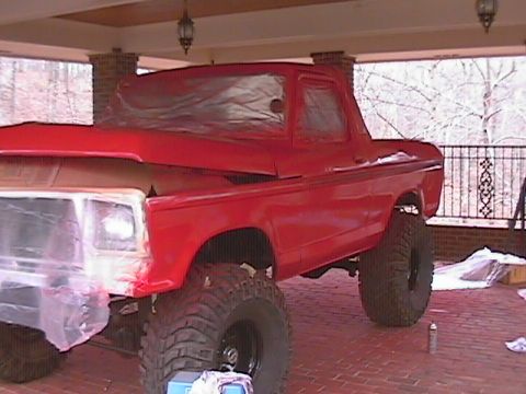 1979 Ford Bronco - A red Ford Bronco is being prepped for paint with its hood open and windows covered.