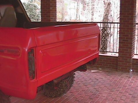 1979 Ford Bronco - Rear view of a red 1979 Ford Bronco, showing its distinctive body lines and off-road tire.