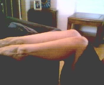 1995 Ford Bronco - A close-up view of legs resting on furniture, with a room interior in the background.