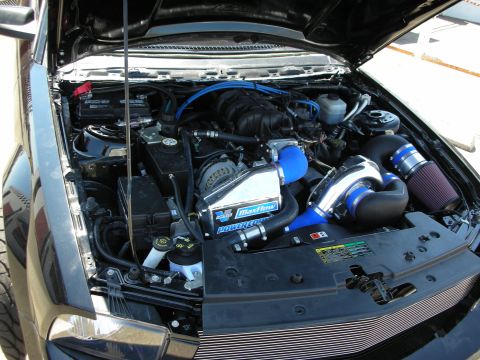 1992 Ford Crown Victoria - The engine bay features a custom intake system with blue piping and a prominent MaxFlow PowerCore air filter.