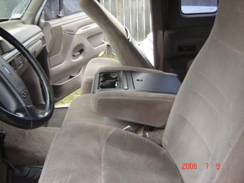 1993 Ford Bronco - The interior of a truck shows the driver's side, center console, and passenger seat.