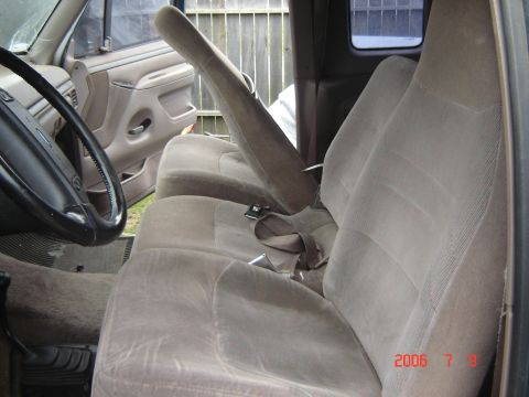 1993 Ford Bronco - Close-up of a car's interior, showing the seat and part of the dashboard.