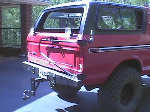 1979 Ford Bronco - Rear view of a red 1978 Ford Bronco, modified with a spare tire carrier and tow hitch.