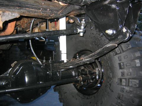 1979 Ford Bronco - Close-up view of the suspension and large tires on a 1979 Ford Bronco.