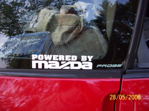 1996 Ford Probe - A red car displays a "POWERED BY MAZDA PROBE" sticker, contradicting the registry's claim.