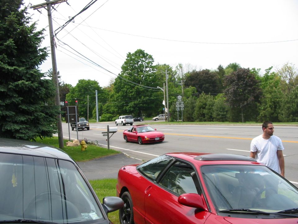 Red 1996 Ford Probe convertible in 3/4 front view on a street