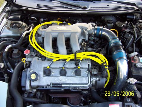 1996 Ford Probe - Engine bay photo showing a Ford V6 engine with yellow spark plug wires and custom intake.