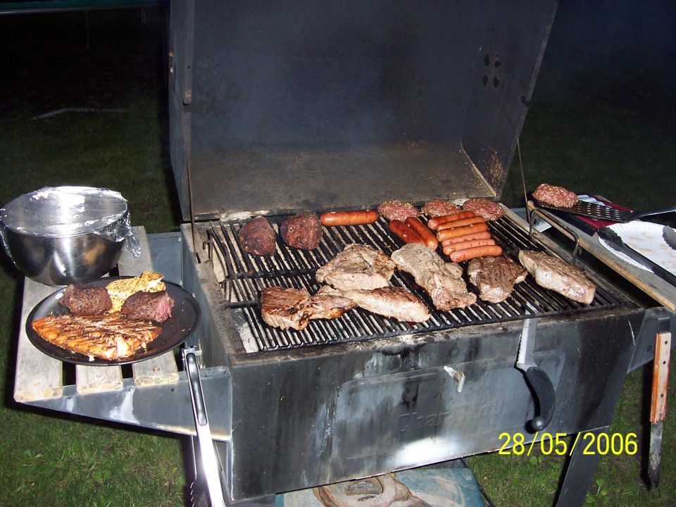 barbecue grill cooking steaks, burgers, and hot dogs. Date stamp reads 28/05/2006