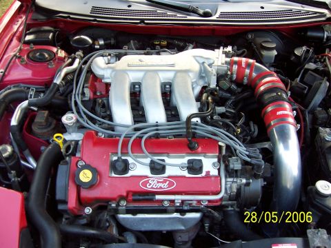 1996 Ford Probe - Close-up of a Ford engine bay, showing the intake system and valve cover with a date stamp.