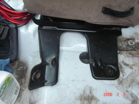 1993 Ford Bronco - Close-up of a vehicle's interior seat mounting bracket, with a visible date stamp indicating '2006 7 9'.