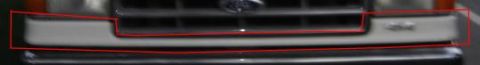 1988 Ford Bronco - Close-up of a Ford truck's front grille and bumper, showing distinctive horizontal bars.