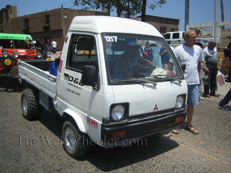 White Mitsubishi mini kei truck number 1217 with D&S decals at a race staging area
