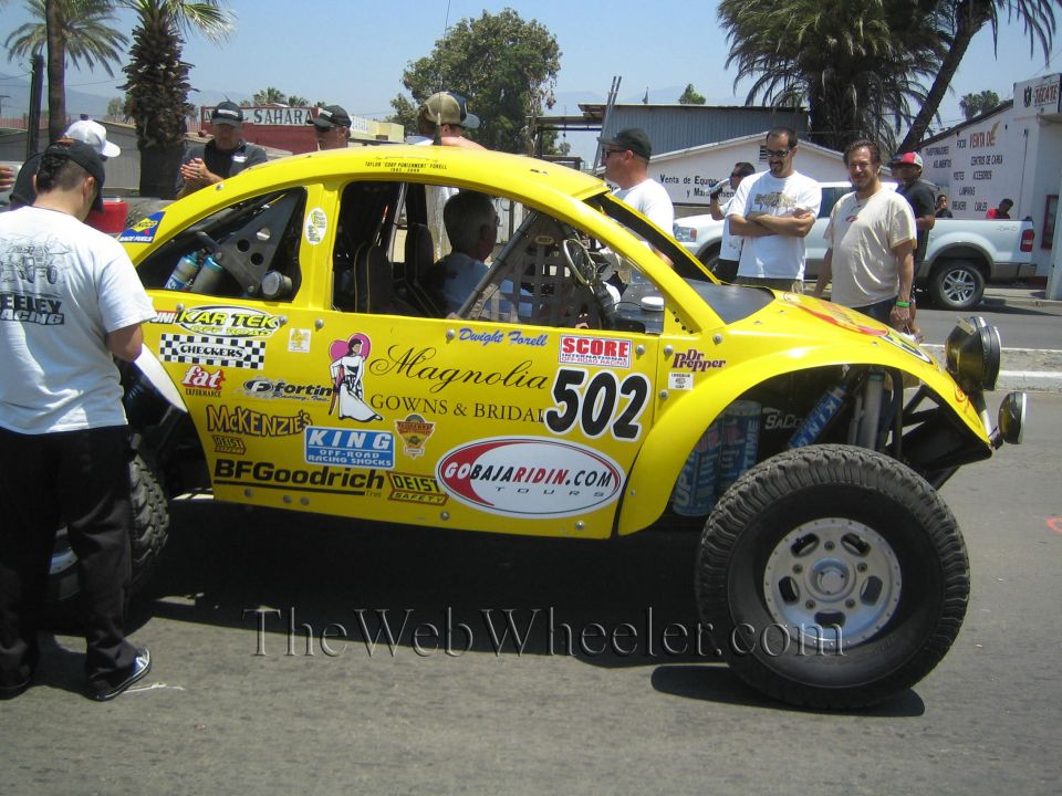 Yellow Baja Bug race car number 502 with Magnolia Gowns and gobajaridin.com decals