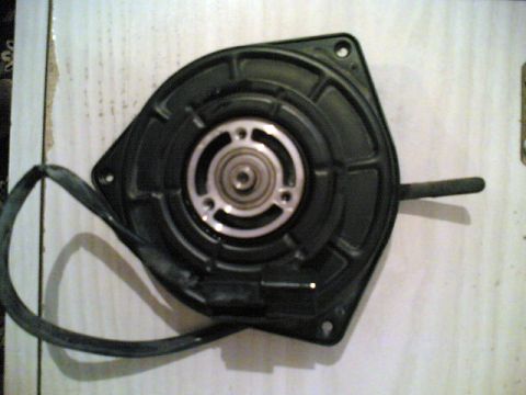 2000 Mitsubishi Montero - Blower motor assembly with attached wire harness, likely for an HVAC system.