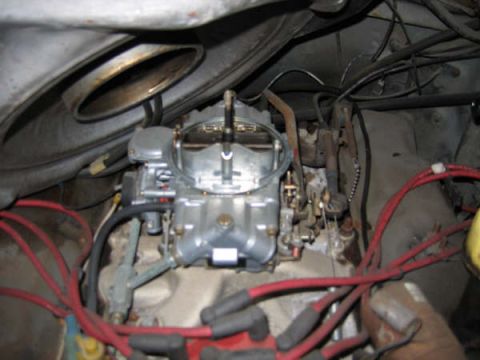 1986 Ford C-350 (Centurion Conversions) - Close-up view of a vehicle's engine compartment, focusing on the carburetor and associated wiring.