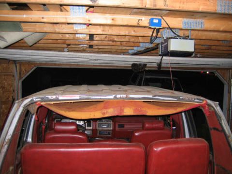 1986 Ford C-350 (Centurion Conversions) - Interior of a van, possibly from the 1980s, with red upholstery and a glimpse of another vehicle behind it.