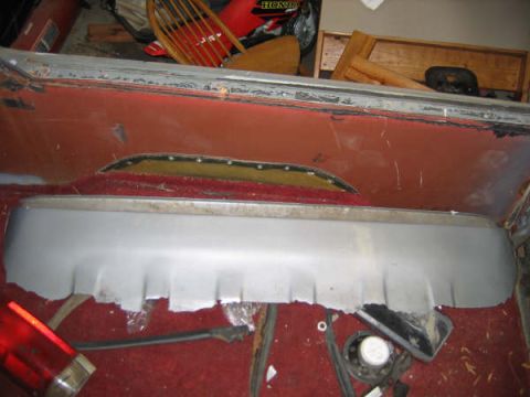 1986 Ford C-350 (Centurion Conversions) - Close-up of a vehicle's interior, showing a damaged silver trim piece and red carpeting.