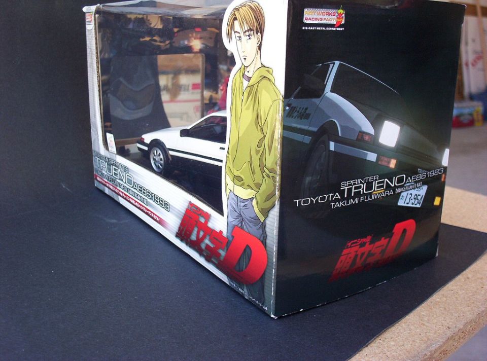 Angled view of boxed Initial D AE86 Trueno die-cast model sitting on a dark surface