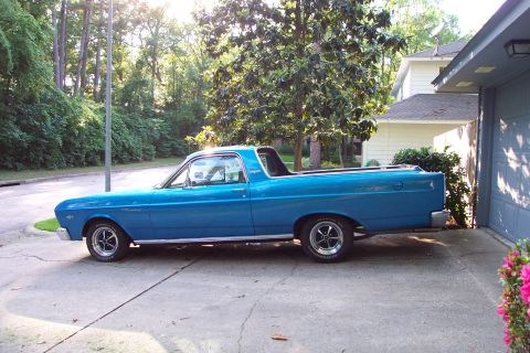 1966 Ford Ranchero - A blue 1966 Ford Ranchero is parked in a driveway next to a garage.
