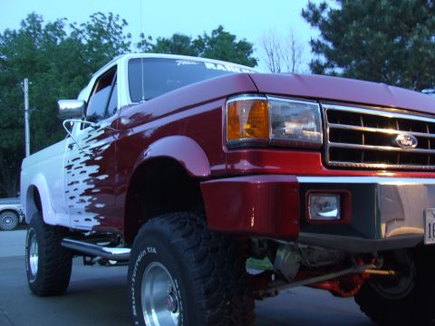 1988 Ford F-150 - This pickup truck features a two-tone paint scheme with custom graphics on the driver's side.