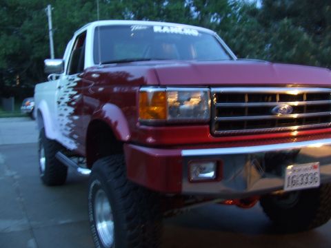 1988 Ford F-150 - This lifted Ford F-150 features a two-tone paint scheme with custom graphics on the side.