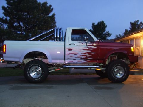 1988 Ford F-150 - This lifted 1988 Ford F-150 features custom paint and dual exhaust stacks.