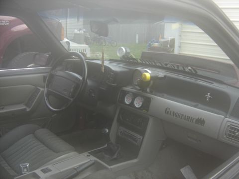 1988 Ford Bronco - Interior view of a 1988 Ford Mustang, showing aftermarket gauges and custom dash decal.