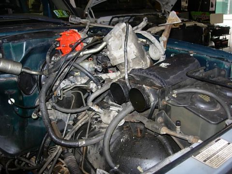 1993 Ford Bronco - Close-up view of a vehicle's engine compartment, showing various components and wiring.