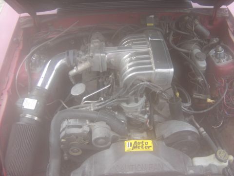 1988 Ford Bronco - Close-up view of a vehicle's engine bay, showing the intake and air filter system.