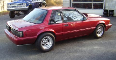 1988 Ford Bronco - This 1988 Ford Bronco coupe features a deep red paint job and aftermarket racing wheels.