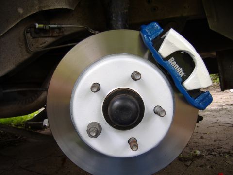 1998 Ford Taurus - Brake caliper and rotor assembly, likely a replacement part.