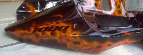 1978 Ford Mustang II - A motorcycle fairing with custom flame paint and "1000" lettering is shown up close.