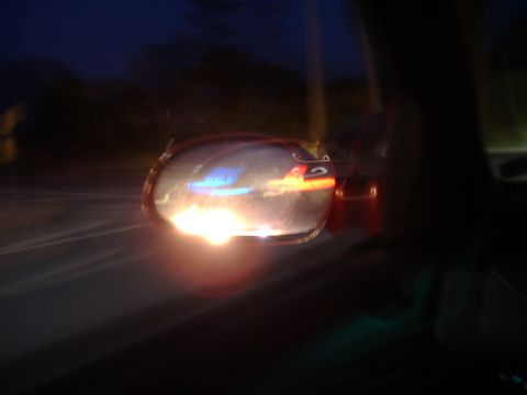 1998 Ford Taurus - Blurred reflection in the side mirror captures the essence of a night drive.