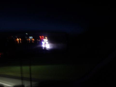 1998 Ford Taurus - Motion blur captures the lights of several vehicles on a dark road.