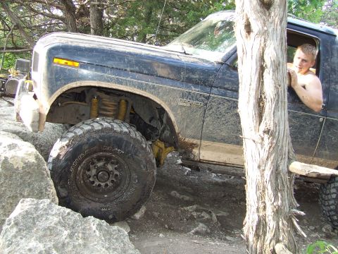1986 Ford Bronco - Ford Bronco navigating difficult rocky terrain off-road.