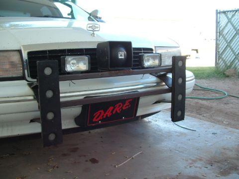 1990 Ford Bronco - White car with a push bar and DARE license plate is shown from the front.