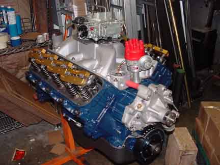 1979 Ford Bronco - A blue V8 engine with gold valve covers and a red distributor cap is shown on an engine stand.