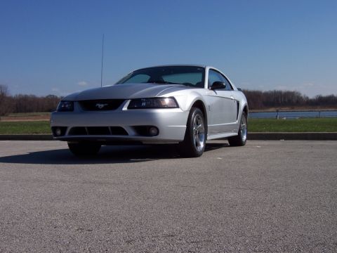 1998 Ford Taurus - This silver Ford Mustang coupe is seen from the front 3/4 angle.