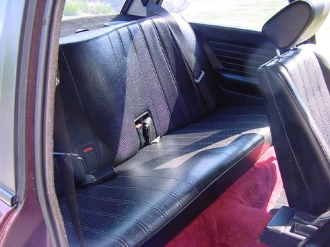 1984 BMW 3 Series - Interior view of a car's rear seating area, showing the bench seat and floor carpet.