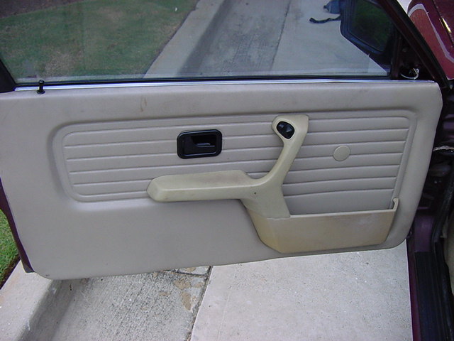 car door panel with armrest and door handle