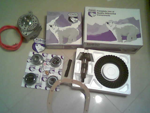 Yukon Gear ring and pinion set, bearing kit and boxes laid out with an alternator