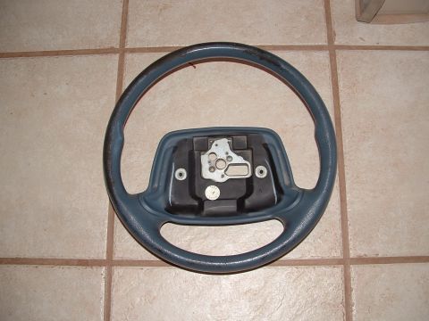 1990 Ford Bronco - A detached steering wheel is shown, likely removed from a vehicle for repair or replacement.