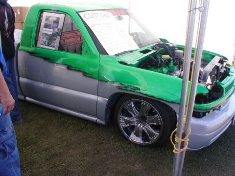 1998 Ford Taurus - Custom pickup truck with two-tone paint and aftermarket wheels is displayed with its hood open.