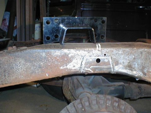 1998 Ford Taurus - A metal bracket is attached to the frame of a vehicle, showing signs of rust and modification.